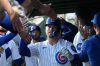 Chicago Cubs' Nico Hoerner (2) is greeted in the dugout after driving in a run against the Los Angeles Angels during the first inning in a baseball game Monday, March 30, 2026, in Chicago. (AP Photo/David Banks)