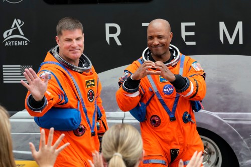 Astronauts, Mission Specialist Jeremy Hansen, of Canada, and Pilot Victor Glover wave to family members as they leave the Operations and Checkout Building for a trip to Launch Pad 39-B and a planned liftoff on NASA's Artemis II moon rocket at the Kennedy Space Center Wednesday, April 1, 2026, in Cape Canaveral, Fla. (AP Photo/Chris O'Meara)