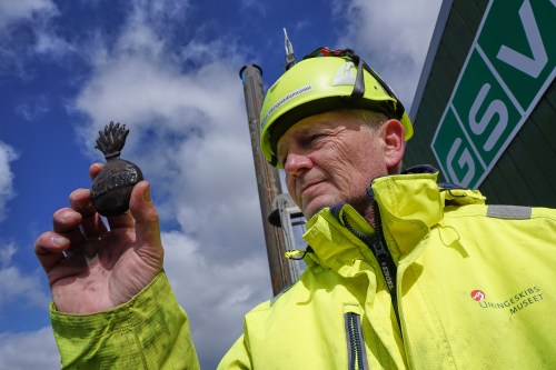 Morten Johansen, head of maritime archaeology at Denmark's Viking Ship Museum, shows a metal insignia recovered from the wreck of Danish flagship 