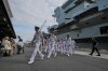 FILE - Crews walk near the Royal Navy aircraft carrier HMS Prince of Wales before its port call in Tokyo Thursday, Aug. 28, 2025. (AP Photo/Eugene Hoshiko, File)