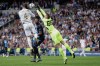 FILE - From left, Real Madrid's Sergio Ramos, Brugge's Simon Deli and Brugge's goalkeeper Simon Mignolet go for the ball during the Champions League group A soccer match between Real Madrid and Club Brugge, at the Santiago Bernabeu stadium in Madrid, Oct.1, 2019. (AP Photo/Manu Fernandez, File)