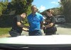 In this image from police body camera video released by the Martin County, Fla., Sheriff's Office, golfer Tiger Woods is taken into custody by sheriff's deputies following a car crash in Jupiter Island, Fla., Friday, March 27, 2026. (Martin County Sheriff's Office via AP)