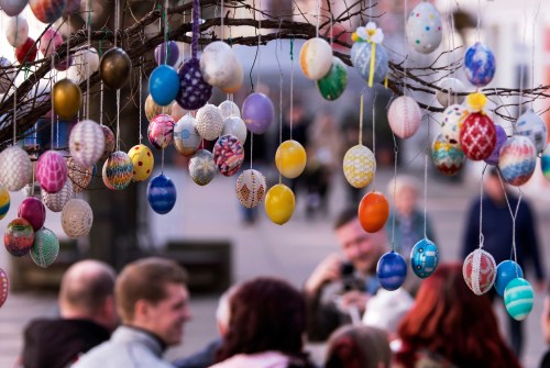 FILE - Painted Easter eggs hang from an Easter Tree in Saalfeld, central Germany, March 30, 2018. (AP Photo/Jens Meyer, File)