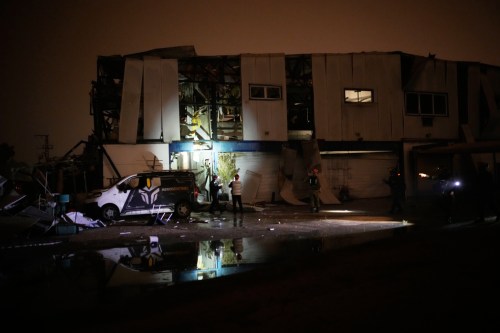 Israeli security forces and rescue teams inspect a site struck by an Iranian missile in Petah Tikva, Israel,Thursday, April 2, 2026. (AP Photo/Ohad Zwigenberg)