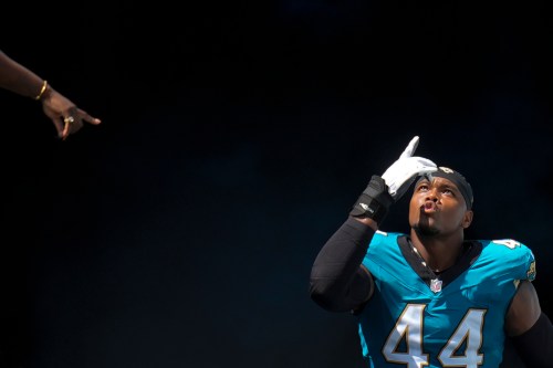 FILE - A spectator gestures as Jacksonville Jaguars defensive end Travon Walker is introduced onto the field prior to an NFL football game against the Houston Texans Sunday, Sept. 21, 2025, in Jacksonville, Fla. (AP Photo/John Raoux, File)