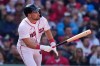 Boston Red Sox's Caleb Durbin watches the flight of his RBI single off San Diego Padres pitcher Michael King during the fourth inning on a home-opener baseball game at Fenway Park, Friday, April 3, 2026, in Boston. (AP Photo/Charles Krupa)