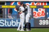 New York Yankees outfielders Cody Bellinger (35), Trent Grisham (12) and Aaron Judge (99) embrace each other after wining a home-opener baseball game against the Miami Marlins, Friday, April 3, 2026, in New York. (AP Photo/Yuki Iwamura)