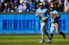 Milwaukee Brewers outfielders Garrett Mitchell (5) and Sal Frelick run off the field after the first baseball game of a doubleheader against the Kansas City Royals, Saturday, April 4, 2026, in Kansas City, Mo. (AP Photo/Charlie Riedel)