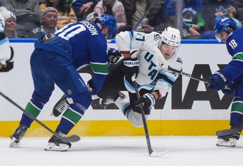Utah Mammoth's John-Jason Peterka (77) is upended by Vancouver Canucks' Elias Pettersson (40) during the second period of an NHL hockey game, in Vancouver, on Saturday, April 4, 2026. THE CANADIAN PRESS/Darryl Dyck