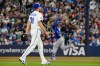 Blue Jays pitcher Max Scherzer (31) walks back to the mound as Los Angeles Dodgers slugger Teoscar Hernández (37) rounds the bases after hitting a two-run homer in a Major League Baseball game in Toronto on April 6, 2026. THE CANADIAN PRESS/Frank Gunn