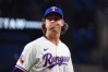 Texas Rangers starting pitcher Jacob deGrom reacts after pitching to the Seattle Mariners during the fourth inning of a baseball game Monday, April 6, 2026, in Arlington, Texas. (AP Photo/Julio Cortez)