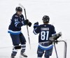 Winnipeg Jets' Kyle Connor (81) celebrates his goal against the Seattle Kraken with Mark Scheifele (55) during second period NHL hockey action in Winnipeg, Monday, April 6, 2026. THE CANADIAN PRESS/Fred Greenslade