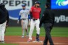Cleveland Guardians' Gabriel Arias, second from right, at second base after pulling up with an injury after running to second on a double in the fifth inning of a baseball game against the Kansas City Royals in Cleveland, Monday, April 6, 2026. (AP Photo/Sue Ogrocki)