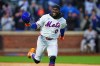 New York Mets' Ronny Mauricio (0) celebrates after hitting a game winning walk-off single during the tenth inning of a baseball game against the Arizona Diamondbacks Tuesday, April 7, 2026, in New York. (AP Photo/Frank Franklin II)