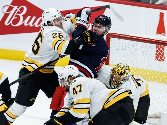 Boston Bruins' Andrew Peeke (26) defends against Winnipeg Jets' Jonathan Toews (19) in front of goaltender Joonas Korpisalo (70) during their Dec. 11 game. (John Woods / The Canadian Press files)
