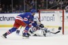 Winnipeg Jets goaltender Eric Comrie, right, makes a save against New York Rangers center J.T. Miller (8) in a shootout of an NHL hockey game, Sunday, March 22, 2026, in New York. (AP Photo/Heather Khalifa)