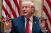 President Donald Trump holds up two Sharpie pens as he speaks during a Cabinet meeting at the White House, Thursday, March 26, 2026, in Washington. (AP Photo/Alex Brandon)