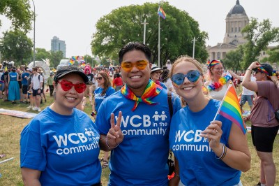 Employees at Workers Compensation Board of Manitoba walk in the Winnipeg Pride Parade.