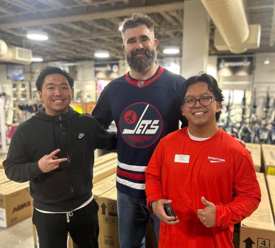 SportChek Polo Park employee Lean, left, poses with Jason Kelce and another employee Sunday. (Supplied)