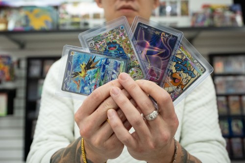 Co-owner of trading card store Team Collectors, Max Wong displays cards from a showcase in Richmond B.C., on Monday, March 9, 2026. THE CANADIAN PRESS/Ethan Cairns