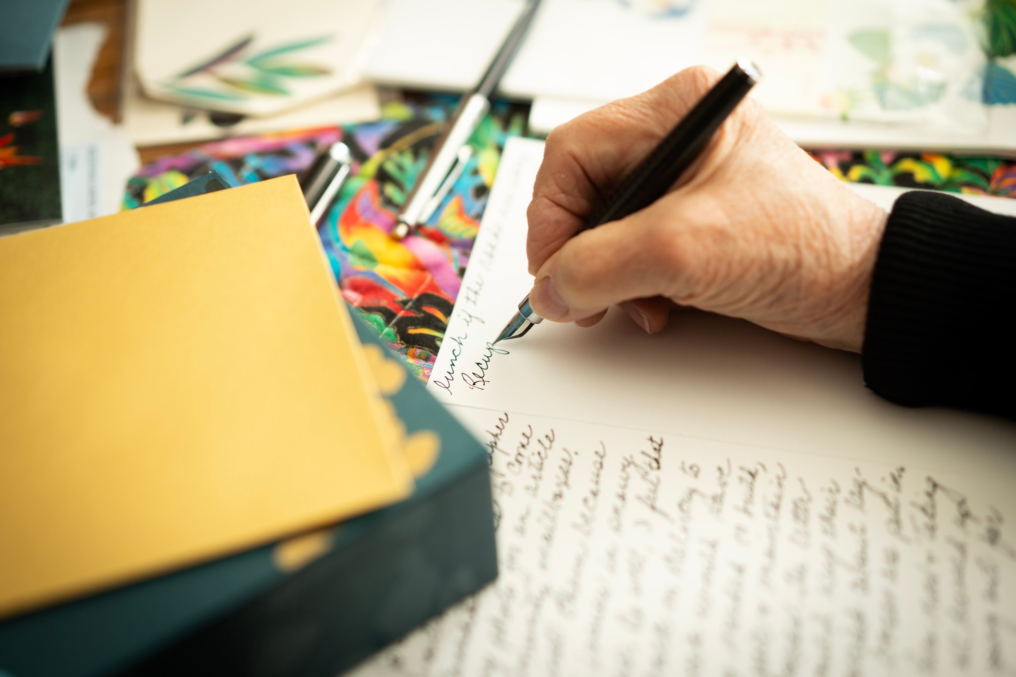 Janet Wees, who is concerned about losing her mail service, writing one of the 400 letters a year she writes and sends by mail in her house in Calgary, Friday, April 17, 2026. THE CANADIAN PRESS/Todd Korol