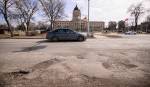 MIKE SUDOMA / FREE PRESS FILES
                                Drivers avoid the long line of potholes at the corner of Broadway and Memorial Boulevard.