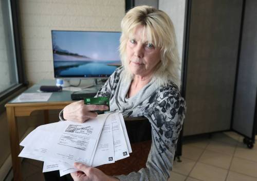 RUTH BONNEVILLE / FREE PRESS
                                Lisa Taron with photocopies of the 21 fake cheques used in an ATM to steal money from her bank account.