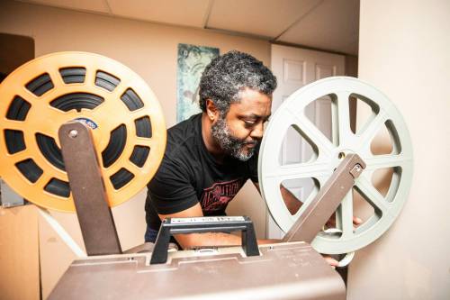 MIKAELA MACKENZIE / FREE PRESS
                                Elyas Tesfaye, a 16mm film buff who digitizes and posts his collection of films on YouTube, loads up the projector on Wednesday, April 8, 2026. For Dave Sanderson story. Free Press 2026