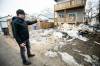 MIKAELA MACKENZIE / FREE PRESS
                                Area resident Kevin Stuart shows a trash pile Monday behind 895 Lorette Ave. He hasn&rsquo;t seen anyone working on the house in months.