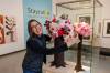 MIKE DEAL / FREE PRESS
                                Karen Lischka with her flower arraignment next to Phyllis Green&rsquo;s, Boob Tree, during the installation of Art in Bloom at the WAG-Qaumajuq, which will be taking place April 17–19.