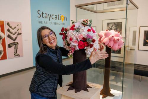 MIKE DEAL / FREE PRESS
                                Karen Lischka with her flower arraignment next to Phyllis Green&rsquo;s, Boob Tree, during the installation of Art in Bloom at the WAG-Qaumajuq, which will be taking place April 17–19.