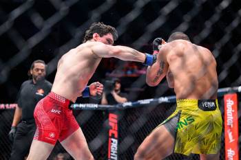 MIKE SUDOMA / FREE PRESS
                                Canadian fighter Mike Malott lands a final punch on Brazilian fighter Gilbert Burns during the third round of their fight to take the win UFC Fight Night Saturday.