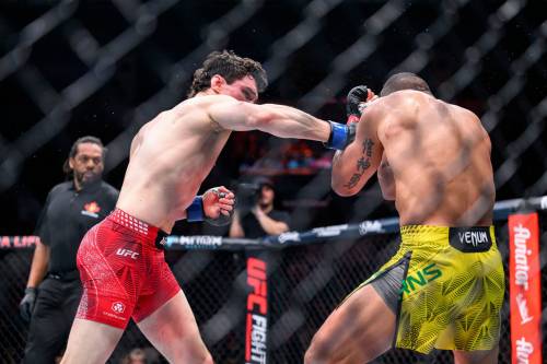 MIKE SUDOMA / FREE PRESS
                                Canadian fighter Mike Malott lands a final punch on Brazilian fighter Gilbert Burns during the third round of their fight to take the win UFC Fight Night Saturday.
