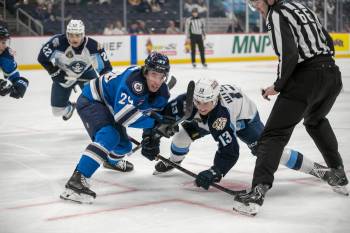 BROOK JONES / FREE PRESS
                                Manitoba Moose centre Brayden Yager (left) and Milwaukee Admirals forward Joey Willis battle in the faceoff circle during their best-of-three AHL play-in series on Wednesday.