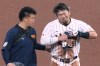 Japan's Seiya Suzuki is helped off the field after being injured at second base at the with the first inning during a World Baseball Classic quarterfinal game against Venezuela, Saturday, March 14, 2026, in Miami. (AP Photo/Marta Lavandier)