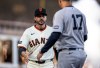 San Francisco Giants manager Tony Vitello reaches out to shake hands with Yankees manager Aaron Boone (17) during introductions before the San Francisco Giants played the New York Yankees in their 2026 Opening Day at Oracle Park in San Francisco, on Wednesday, March 25, 2026. (Santiago Mejia/San Francisco Chronicle via AP)