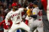 Los Angeles Angels' Jorge Soler (12) and Atlanta Braves' Reynaldo López (40) fight during the fifth inning of a baseball game, Tuesday, April 7, 2026, in Anaheim, Calif. (AP Photo/Ethan Swope)