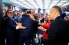 MP Chris d'Entremont, who crossed the floor from the Conservatives to join the Liberals, is embraced by MP Darren Fisher as MP Angelo Iacono reaches to shake hands with Prime Minister Mark Carney as they arrive at a meeting of the Liberal caucus on Parliament Hill in Ottawa on Wednesday, Nov. 5, 2025. THE CANADIAN PRESS/Justin Tang