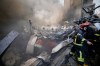 Firefighters, first responders, and volunteers work on smoldering debris at the site of an Israeli airstrike that struck an apartment building in Beirut, Lebanon, Wednesday, April 8, 2026. (AP Photo/Bilal Hussein)