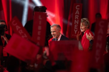 Liberal Leader Mark Carney turns to supporters after it was announced he won the leadership as his wife Diana Fox looks on at the Liberal leadership announcement in Ottawa on Sunday, March 9, 2025. THE CANADIAN PRESS/Adrian Wyld