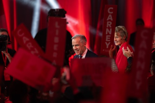 Liberal Leader Mark Carney turns to supporters after it was announced he won the leadership as his wife Diana Fox looks on at the Liberal leadership announcement in Ottawa on Sunday, March 9, 2025. THE CANADIAN PRESS/Adrian Wyld