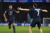 PSG's Desire Doue, left, celebrates with PSG's Khvicha Kvaratskhelia after scoring the opening goal during the Champions League quarterfinal first leg soccer match between Paris Saint-Germain and Liverpool in Paris, Wednesday, April 8, 2026. (AP Photo/Thibault Camus)