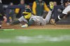Athletics' Lawrence Butler slides home to score during the fourth inning of a baseball game against the New York Yankees, Wednesday, April 8, 2026, in New York. (AP Photo/Heather Khalifa)