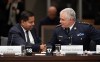 Minister of Public Safety Gary Anandasangaree speaks with Royal Canadian Mounted Police Commissioner Michael Duheme as they shake hands before appearing at the Standing Committee on Public Safety and National Security in Ottawa, Tuesday, March 24, 2026. THE CANADIAN PRESS/Adrian Wyld