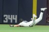Miami Marlins left fielder Griffin Conine (18) misses a catch in the sixth inning of a baseball game against the Cincinnati Reds Thursday, April 9, 2026, in Miami. (AP Photo/Marta Lavandier)