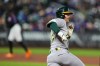 Athletics' Jeff McNeil (22) runs to second base for a double during the fourth inning of a baseball game against the New York Mets Friday, April 10, 2026, in New York. (AP Photo/Frank Franklin II)