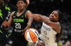 Las Vegas Aces guard Jackie Young loses the ball as she falls against Seattle Storm guard Brittney Sykes (20) during the second half of Game 2 in the first round of the WNBA basketball playoffs Tuesday, Sept. 16, 2025, in Seattle. (AP Photo/Lindsey Wasson)