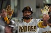 San Diego Padres' Fernando Tatis Jr. celebrates with teammates after hitting a sacrifice fly during the third inning of a baseball game against the Colorado Rockies Thursday, April 9, 2026, in San Diego. (AP Photo/Gregory Bull)