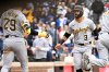 Pittsburgh Pirates' Nick Gonzales (3) celebrates with Ryan O'Hearn (29) after scoring during the 11th inning of a baseball game against the Chicago Cubs, Saturday, April 11, 2026, in Chicago. (AP Photo/Matt Marton)