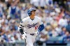 Los Angeles Dodgers designated hitter Shohei Ohtani watches his home run during the first inning of a baseball game against the Texas Rangers, Sunday, April 12, 2026, in Los Angeles. (AP Photo/Caroline Brehman)